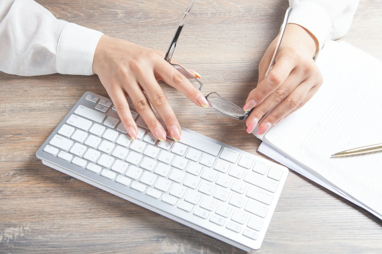 person holding silver apple keyboard